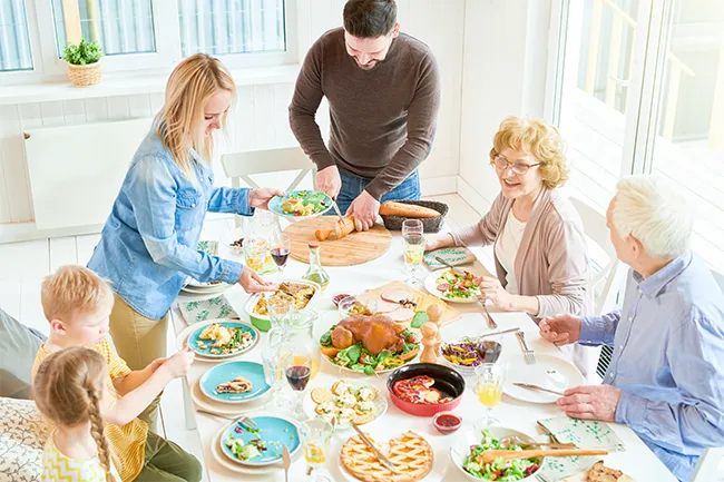 A family at a table about to enjoy dinner